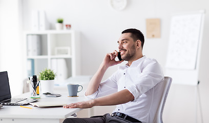 Image showing businessman calling on smartphone at office