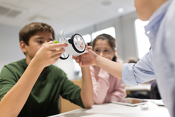 Image showing happy children building robots at robotics school