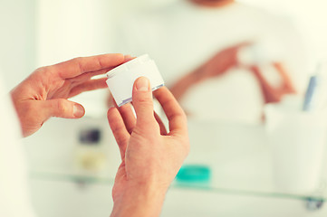 Image showing close up of happy young man with cream at bathroom