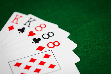 Image showing poker hand of playing cards on green casino cloth