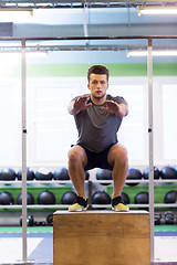 Image showing young man doing box jumps exercise in gym