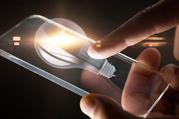 Image showing hands with smartphone and lightbulb projection