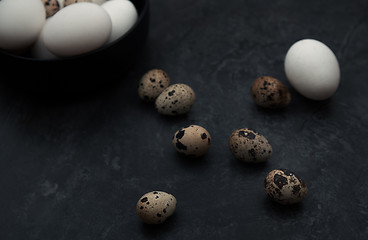 Image showing Quail and chicken eggs on a table