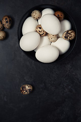 Image showing Quail and chicken eggs on a table