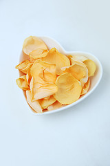 Image showing Rose petals in heart shaped bowl