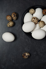 Image showing Quail and chicken eggs on a table