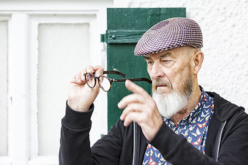 Image showing an old man and his glasses