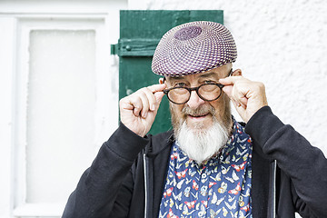 Image showing an old man and his glasses