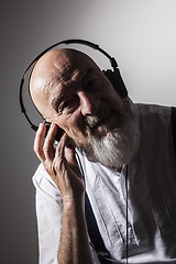 Image showing an old man listening to music