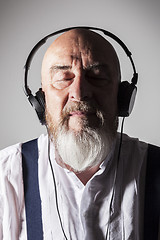 Image showing an old man listening to music