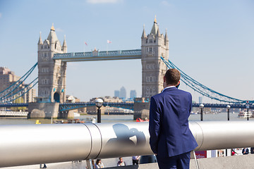 Image showing British businessman talking on mobile phone outdoor in London city, UK.