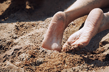 Image showing Legs of woman laying at the beach