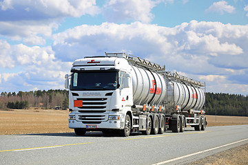 Image showing White Scania Liquid Tanker Trucking on Beautiful Day