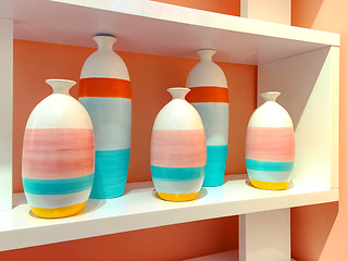 Image showing Colorful ceramic vases on a shelf