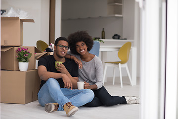 Image showing African American couple relaxing in new house