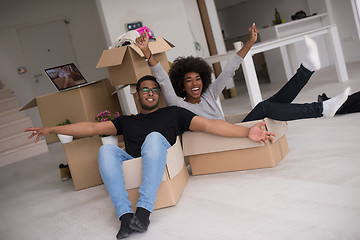 Image showing African American couple  playing with packing material