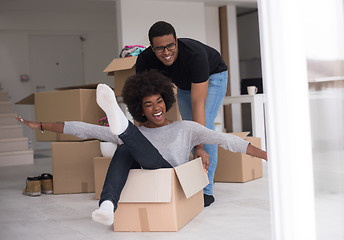 Image showing African American couple  playing with packing material