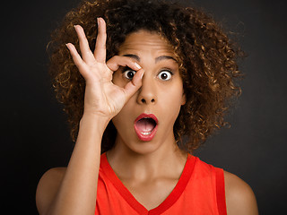 Image showing Beautiful woman looking through her fingers