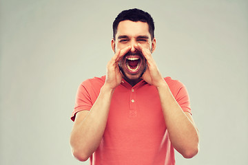 Image showing angry shouting man in t-shirt over gray background