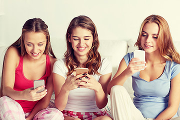 Image showing friends or teen girls with smartphone at home