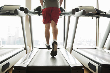 Image showing man exercising on treadmill in gym