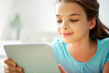 Image showing close up of smiling girl with tablet pc at home