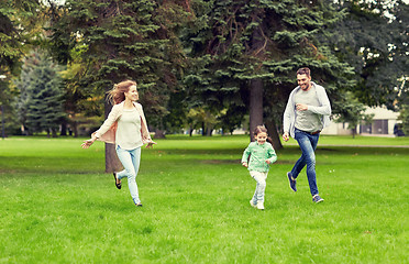 Image showing happy family walking in summer park