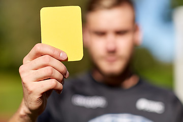 Image showing referee on football field showing yellow card