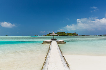 Image showing patio or terrace with palapa and sunbeds on beach