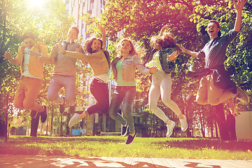 Image showing happy teenage students or friends jumping outdoors