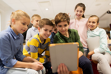 Image showing group of happy children with tablet pc at school