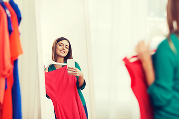 Image showing woman with smartphone taking mirror selfie at home