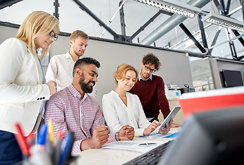 Image showing business team with tablet pc and papers at office