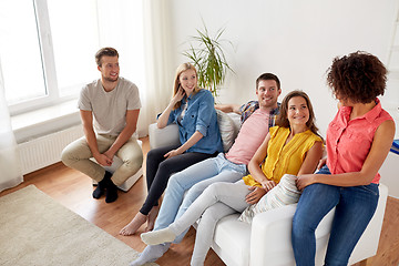 Image showing group of happy friends talking at home