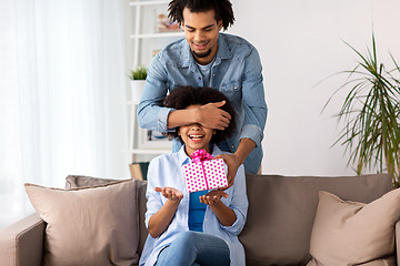 Image showing happy couple with gift box at home