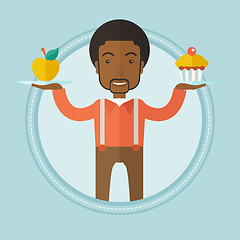 Image showing Man choosing between apple and cupcake.