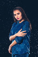 Image showing Young beautiful woman under splash of rain