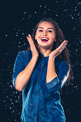 Image showing Young beautiful woman under splash of rain