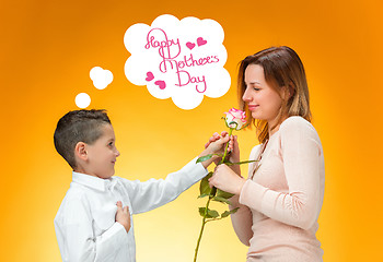 Image showing Young kid giving red rose to his mom