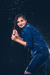 Image showing Young beautiful woman under splash of rain