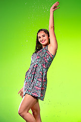 Image showing Young beautiful woman under splash of rain