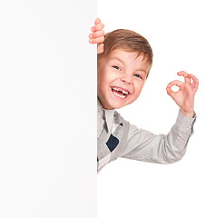 Image showing Little boy peeking from blank board