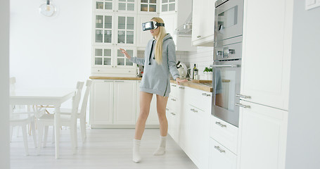 Image showing Young woman experiencing VR glasses