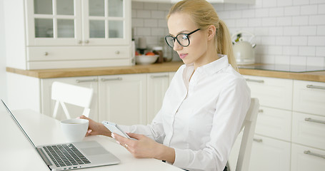 Image showing Successful young woman using devices