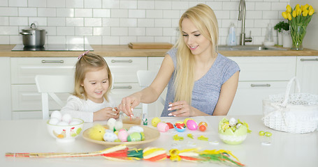 Image showing Charming mother and daughter coloring eggs