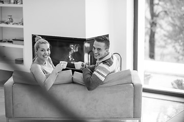 Image showing Young couple  in front of fireplace