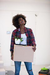 Image showing Black girl moving in the new apartment