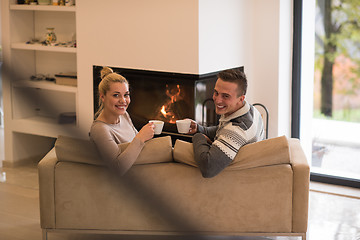 Image showing Young couple  in front of fireplace