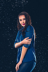 Image showing Young beautiful woman under splash of rain