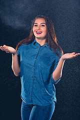 Image showing Young beautiful woman under splash of rain